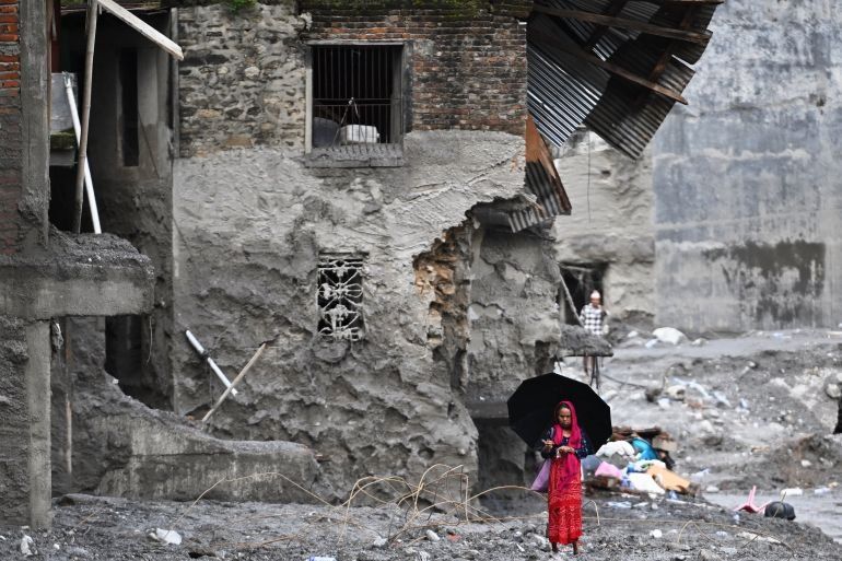 A woman walks among the ruins of flash floods in Nepal's Nuwakot district on September 1, 2026. - Photo: AFP
