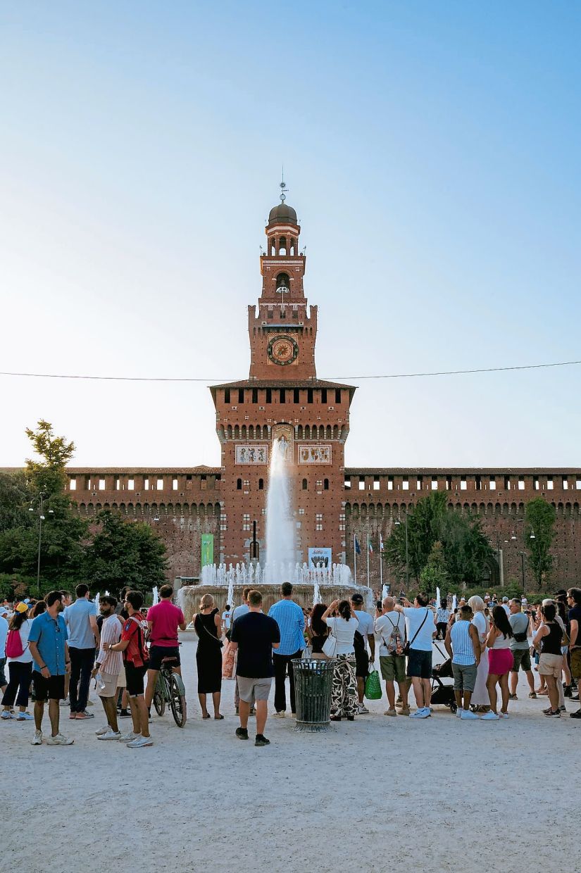 Attractions like the Castello Sforzesco in Italy are understandably crowded during the holidays, but tourists are now visiting local neighbourhoods for that ‘authentic’ experience.
