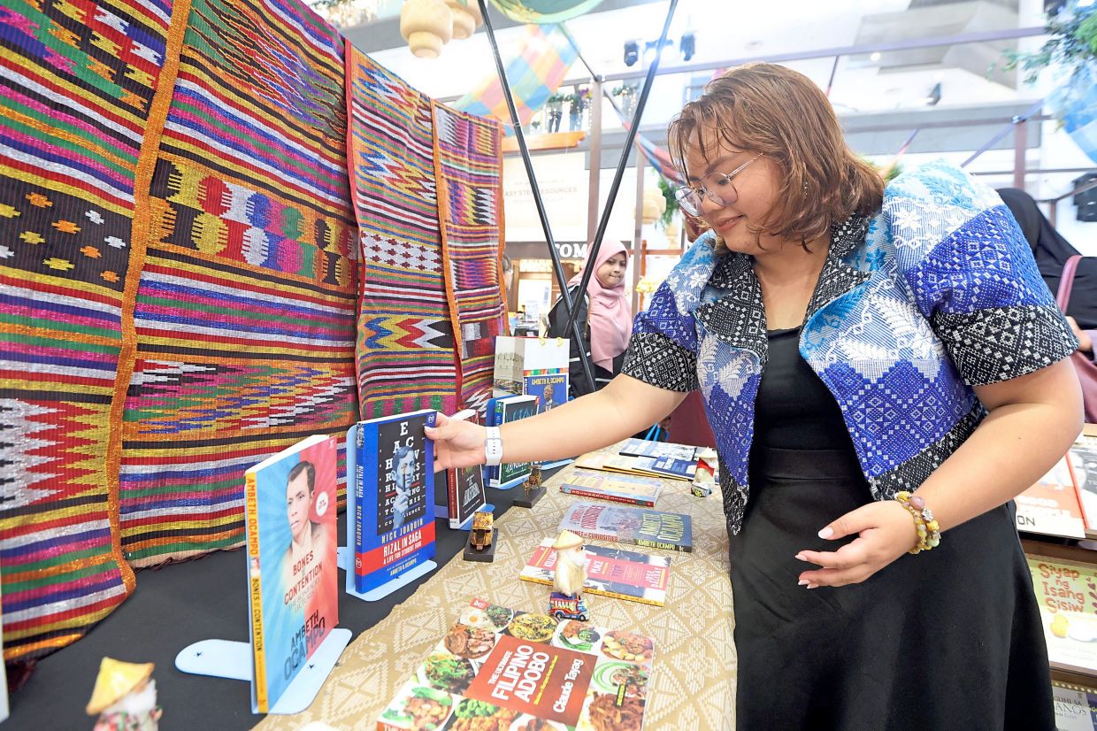 Villamor arranging books about her country’s history and culture showcased at the book bazaar.