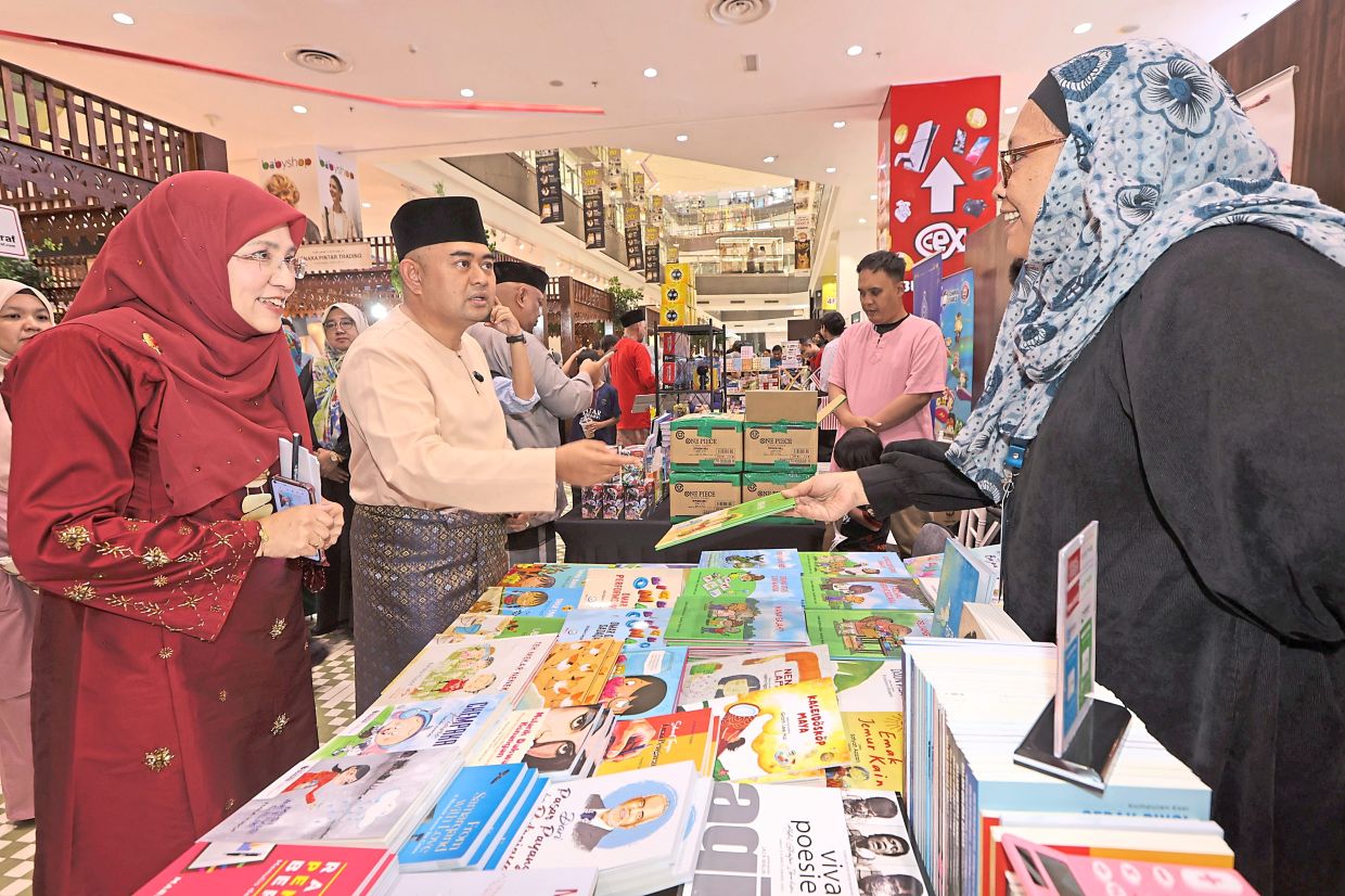 Muhammad Naqib and PPAJ director Ungku Noorakmal Ungku Sulaiman (left) visiting a booth.