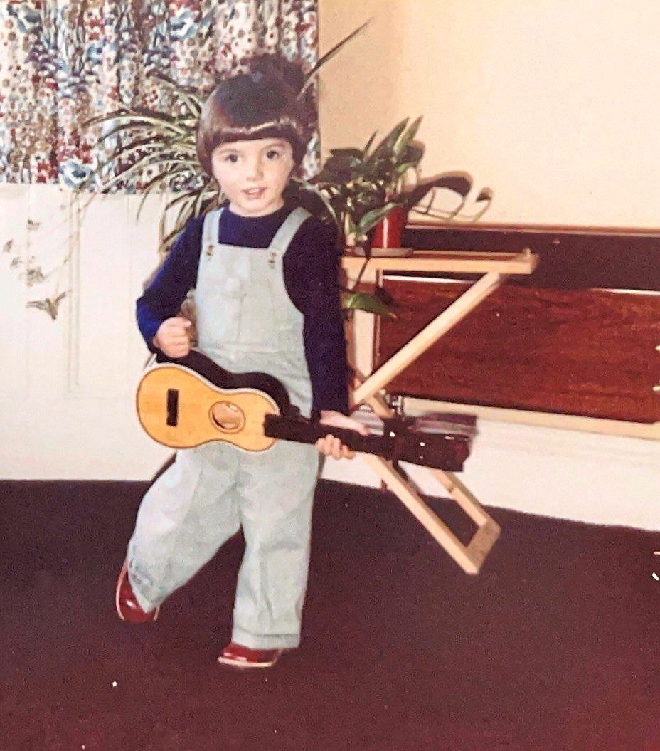 In this undated photo provided by Smith, the musician as a young child poses with a toy guitar.