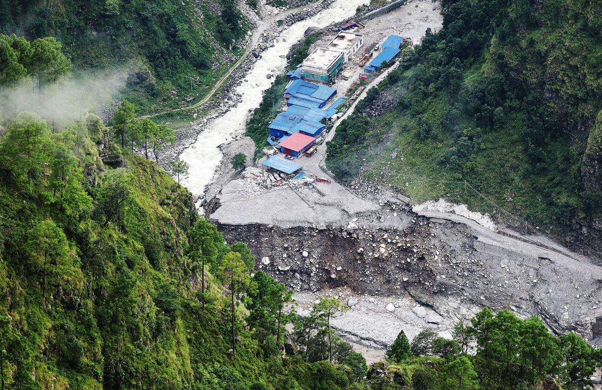 This picture taken on Sept 2, 2026 shows concrete mixer trucks damaged and half-buried in mud following flash floods at the Upper Trishuli-1 (UT-1) Hydropower Plant construction site in Nepal's Rasuwa district. - Photo: Yonhap/AFC