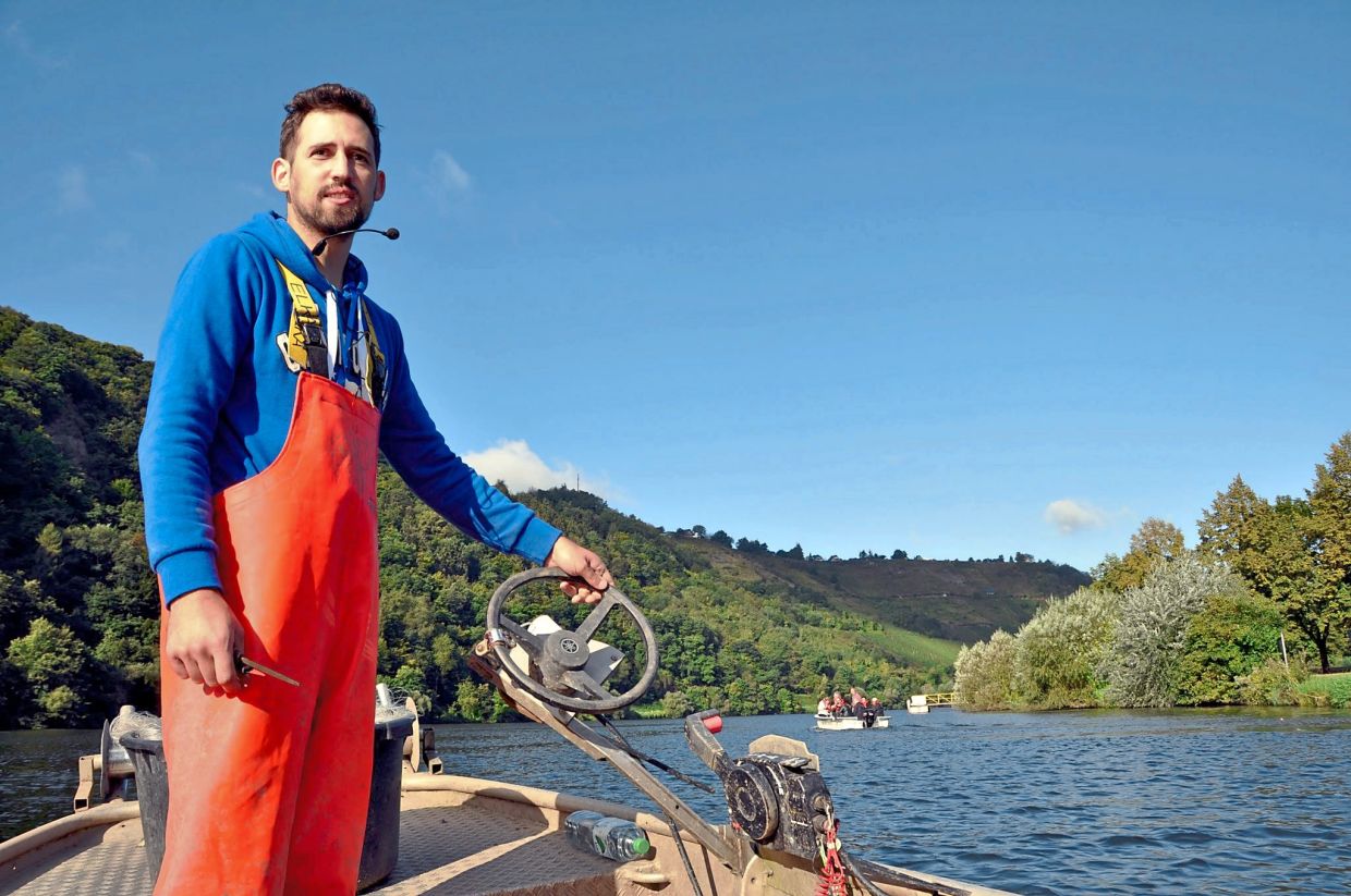Weber is a professional fisherman who takes tourists fishing on his boat on the Moselle.