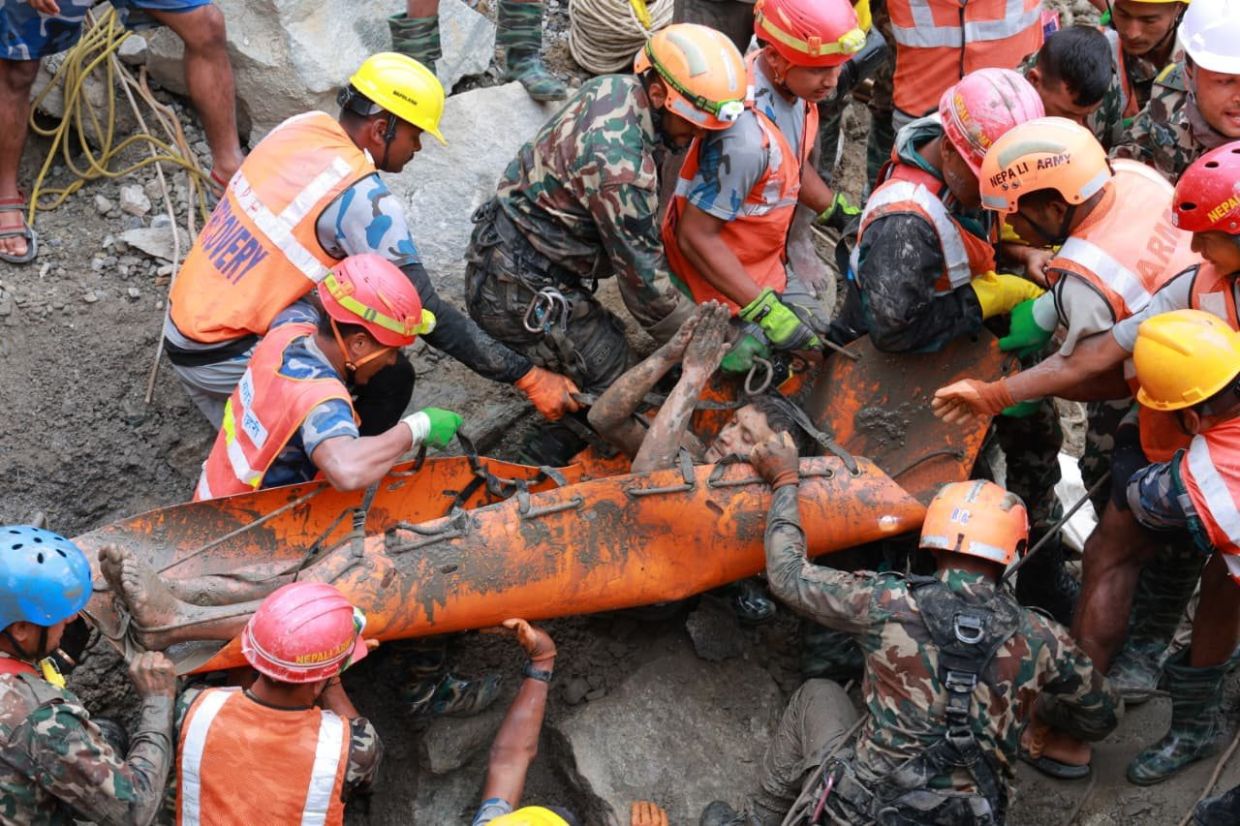 One of the two trapped tunnel workers being stretched out during the rescue operation on Sept 4. - Nepal Army via AP