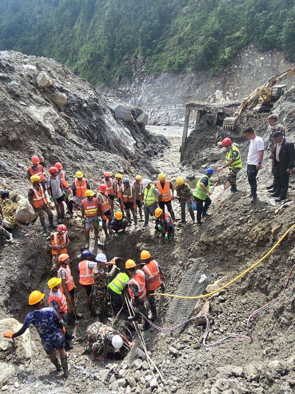 Members of a search and rescue team work to remove the body (not pictured) of a person who was trapped inside a tunnel at the Upper Trishuli-3A Hydropower Project following devastating floods and mudslides that struck the Bhotekoshi River in Rasuwa, Nepal, Sept 4, 2026. - Photo: Reuters