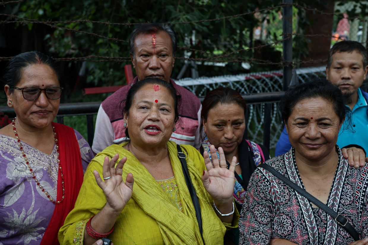 Bidya Dangol (in yellow), the sister of Kabir Maharjan, a survivor pulled out alive after spending nine days trapped in a hydropower station tunnel, talking to media at an army hospital in Kathmandu following flash floods and a mudslide, in Nepal, Sept 4, 2026. - Photo: Reuters