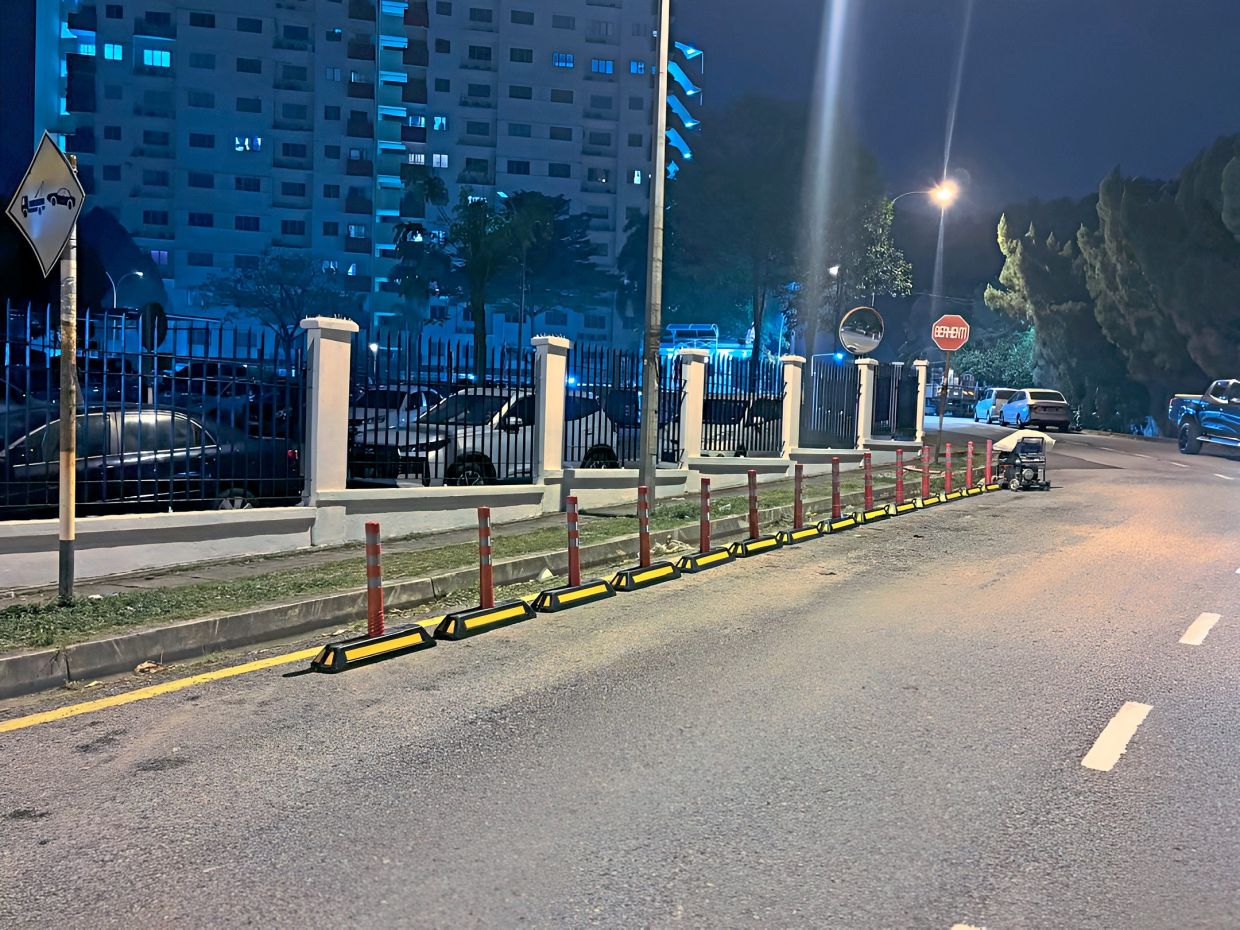 MPKj installed bollards along Jalan Belimbing Indah last month to prevent illegal parking. — Courtesy of TAN KAH HOE