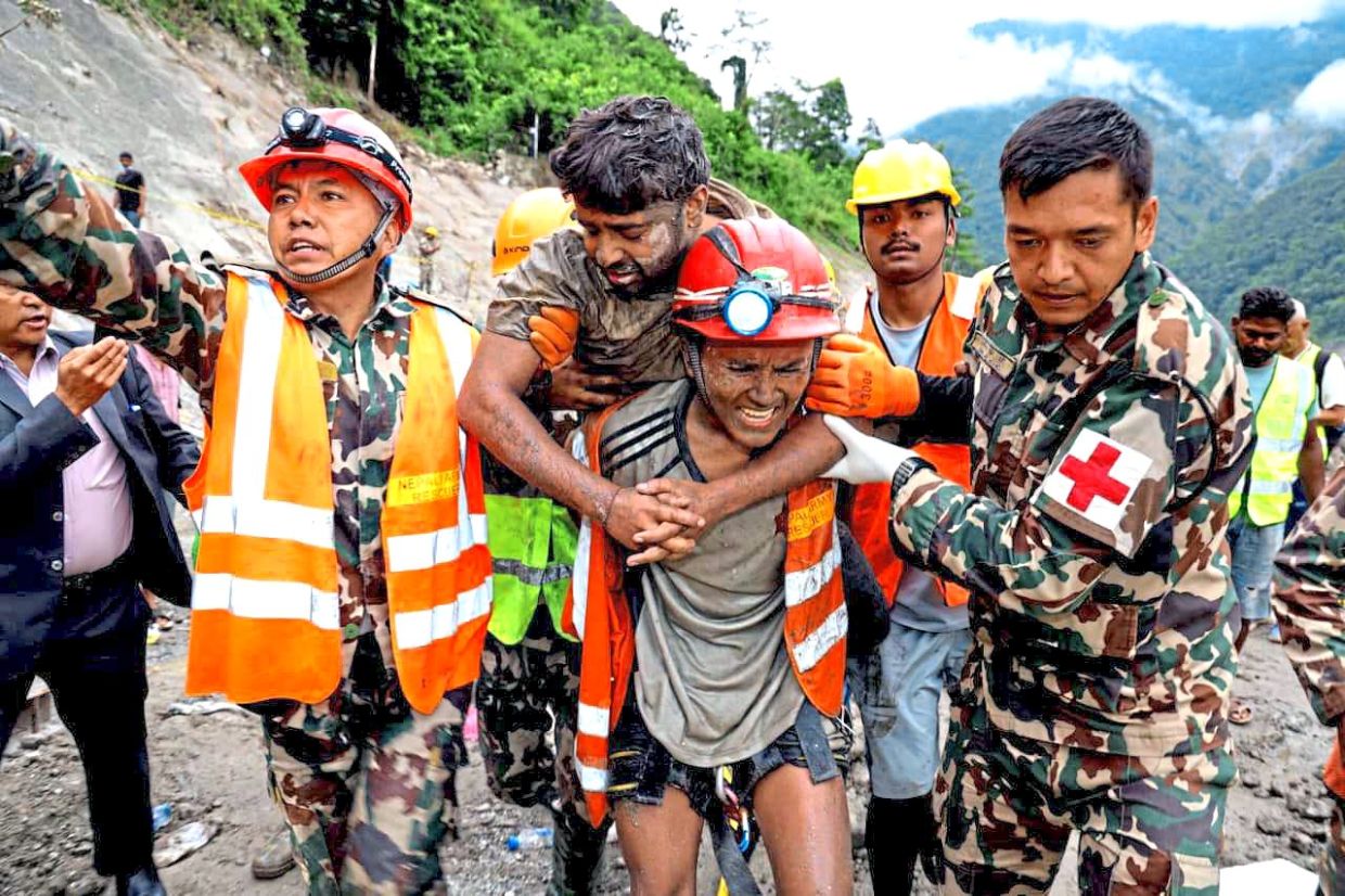 Hope not lost: Rescuers transferring Shah after he was rescued alive in Rasuwa district. — Handout/Nepal army/Xinhua