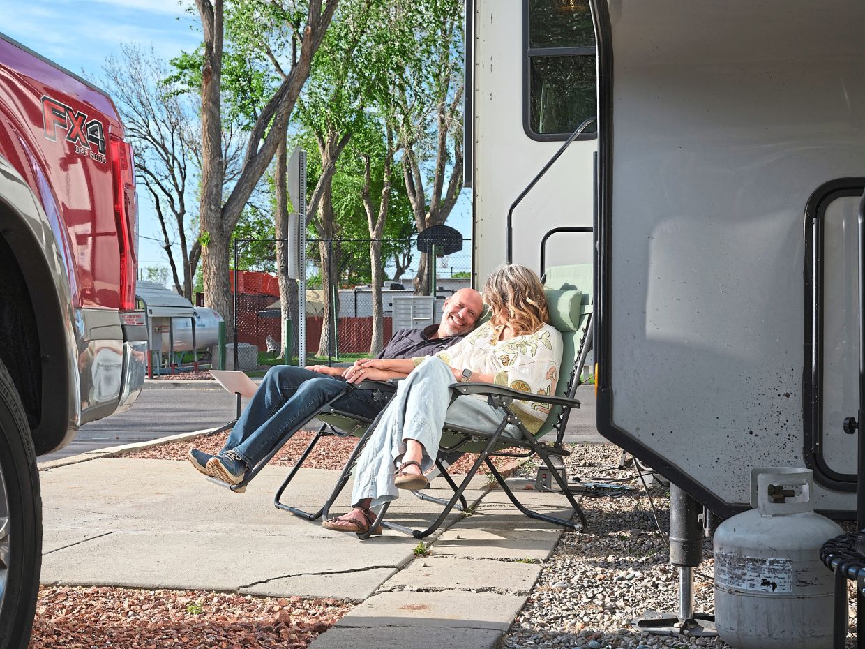 The Evans sit outside their RV, which they lived in for nine years with their four children, and the last three, as empty nesters in Draper, Utah.
