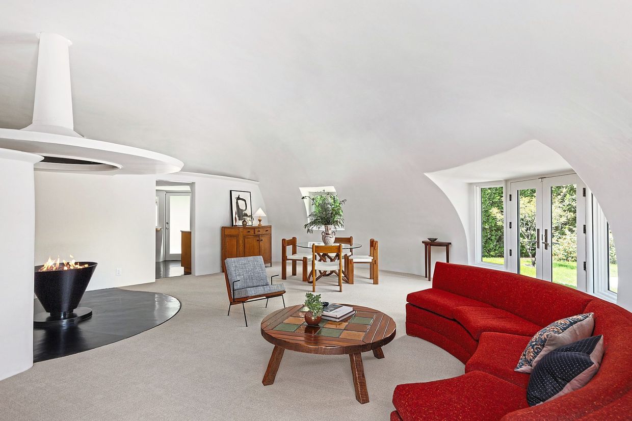 The curved ceiling in the half-circular living room, which features a central fireplace and 'floating' chimney.