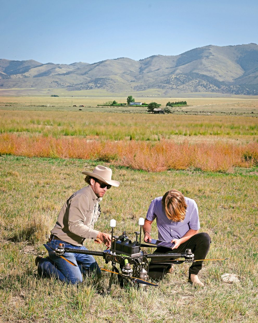 Staff members of Rainmaker preparing a drone for a test flight in southern Idaho. — Alex Goodlett/The New York Times
