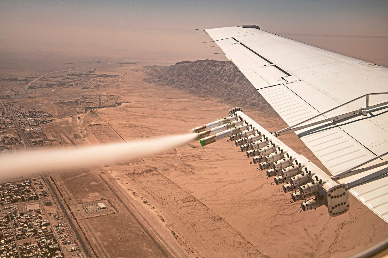Cloud-seeding flares on an aircraft wing during a flight over the United Arab Emirates. — Bryan Denton/The New York Times
