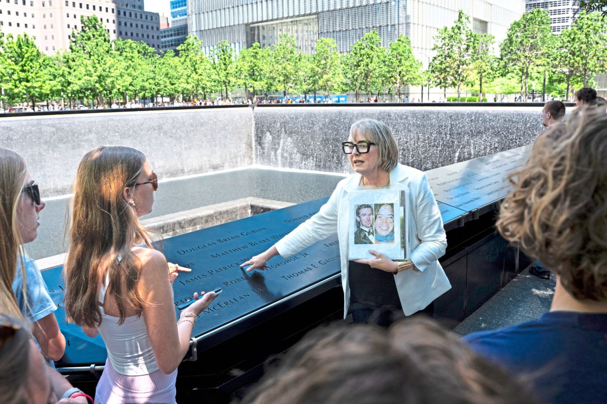 Stanton leading a North Carolina church youth group on a tour at the 9/11 Memorial reflecting pools in lower Manhattan. — Photos: James Estrin/The New York Times