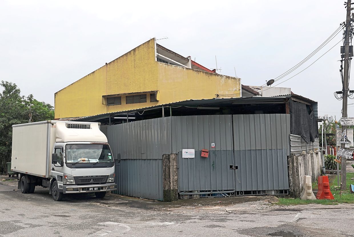 A corner-lot house in a Kuala Lumpur neighbourhood believed to be used as a fruit storage and distribution facility.