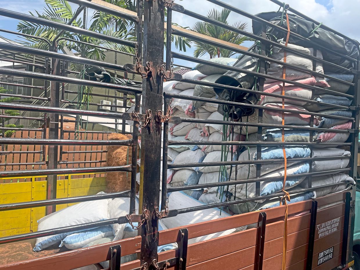 A lorry laden with goods makes a delivery to a house in a residential neighbourhood in Kuala Lumpur, raising concerns that some homes are being used for commercial purposes.