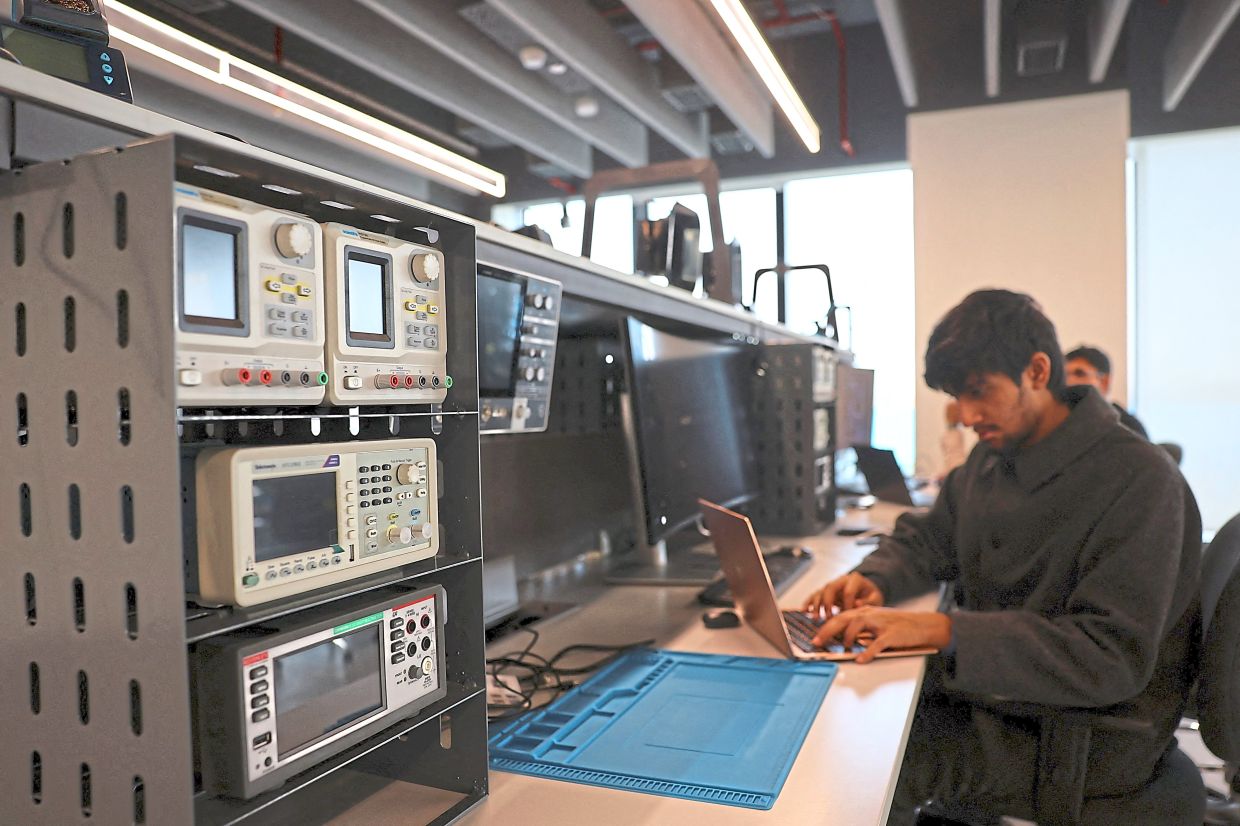 Academic pursuits: A student working on his laptop at a lab at the campus of University of Southampton Delhi. — Reuters 