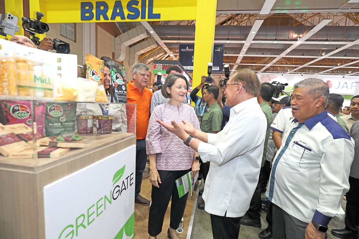 Reaching out: Anwar speaking to Brazilian ambassador to Malaysia Daniella Ortega de Paiva Menezes (left) at Maha 2026. With him is Mohamad Sabu (right). — YAP CHEE HONG/The Star