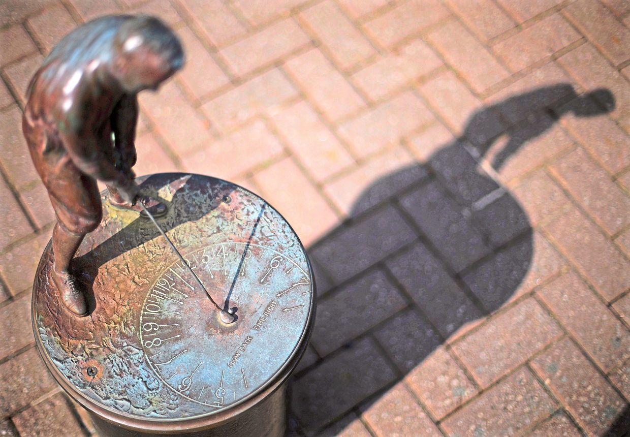 A sundial of golfer Bobby Jones sits outside the Augusta National Golf Club house.