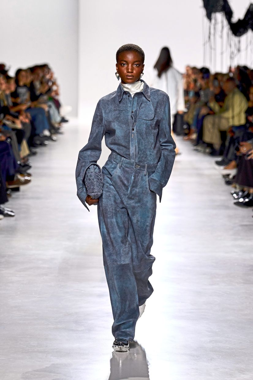 In blue-grey suede, this sophisticated ensemble includes a statement shirt with a unique, sculptural and detachable collar tab. Photo: Bottega Veneta
