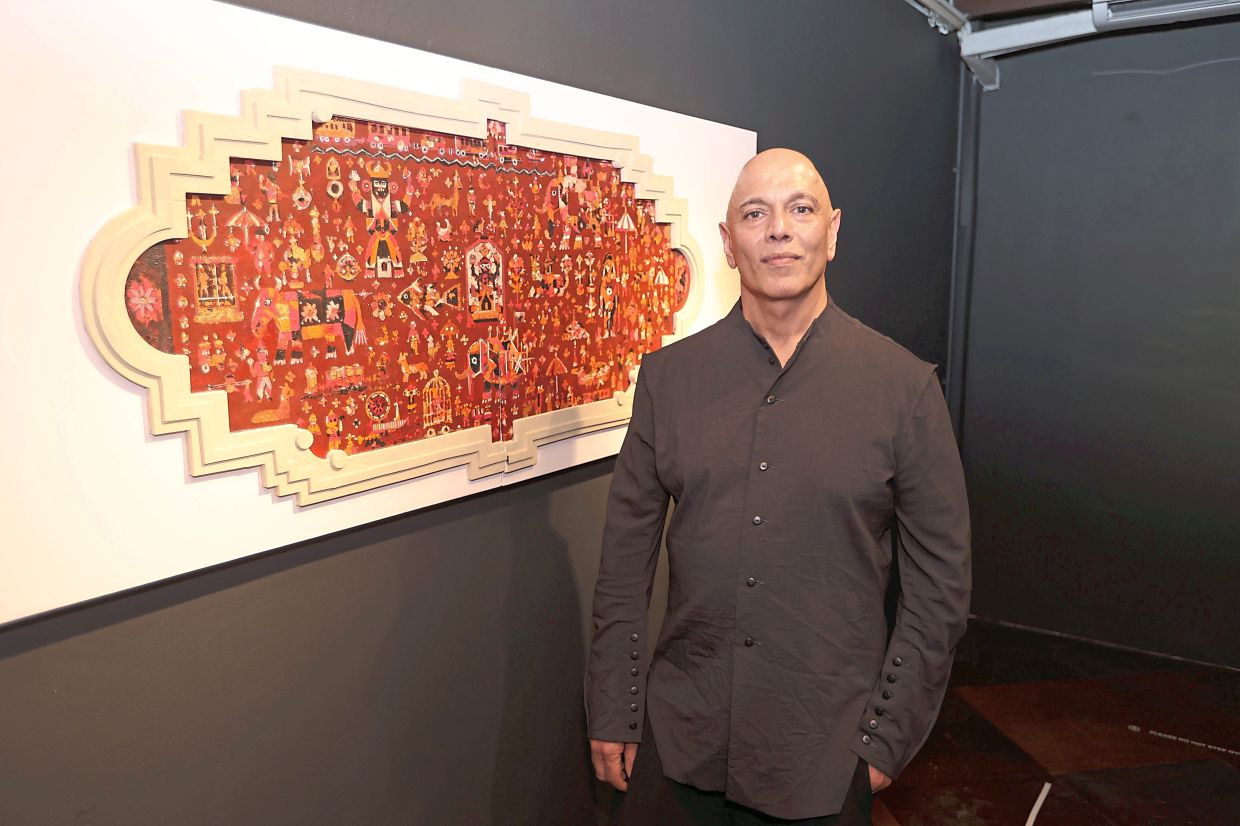 Rajinder stands beside 'Inheritance / Heritage (Virsa)', a 2026 mixed-media work on canvas, EVA foam, acrylic and found materials, at the new exhibition. Photo: The Star/Low Boon Tat
