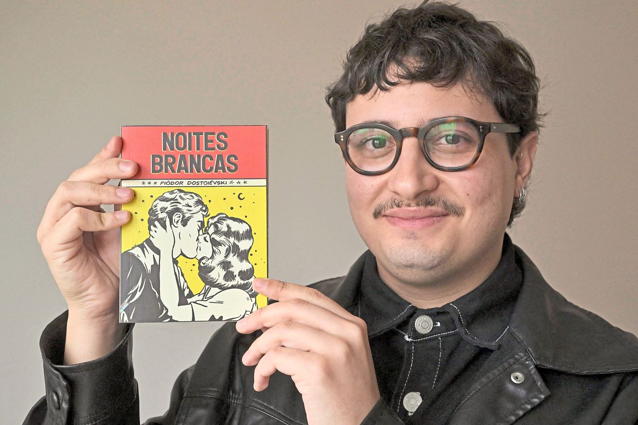 Brazilian book influencer Nogueira, shows a pocket book version of 'White Nights' in Sao Paulo, Brazil. Photo: AFP 