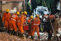 Rescuers search for people trapped in a New Delhi building collapse as death toll rises to 6