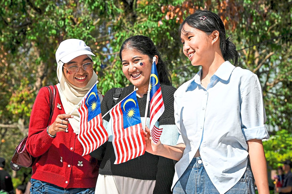 Malaysians of different races come together, reflecting the spirit of unity at the 2026 National Day celebration at Putrajaya Square.