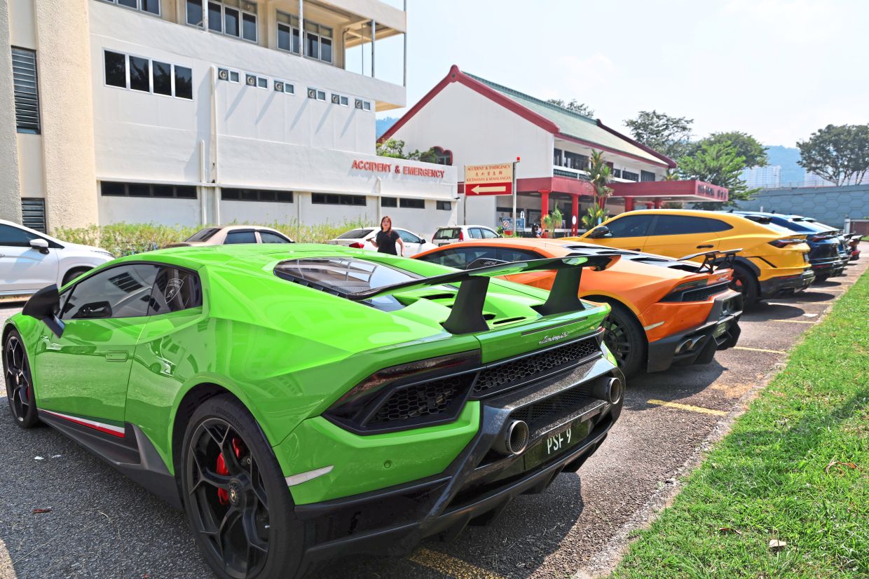 The convoy of Lamborghini supercars making a pit stop at the hospital for a good cause.