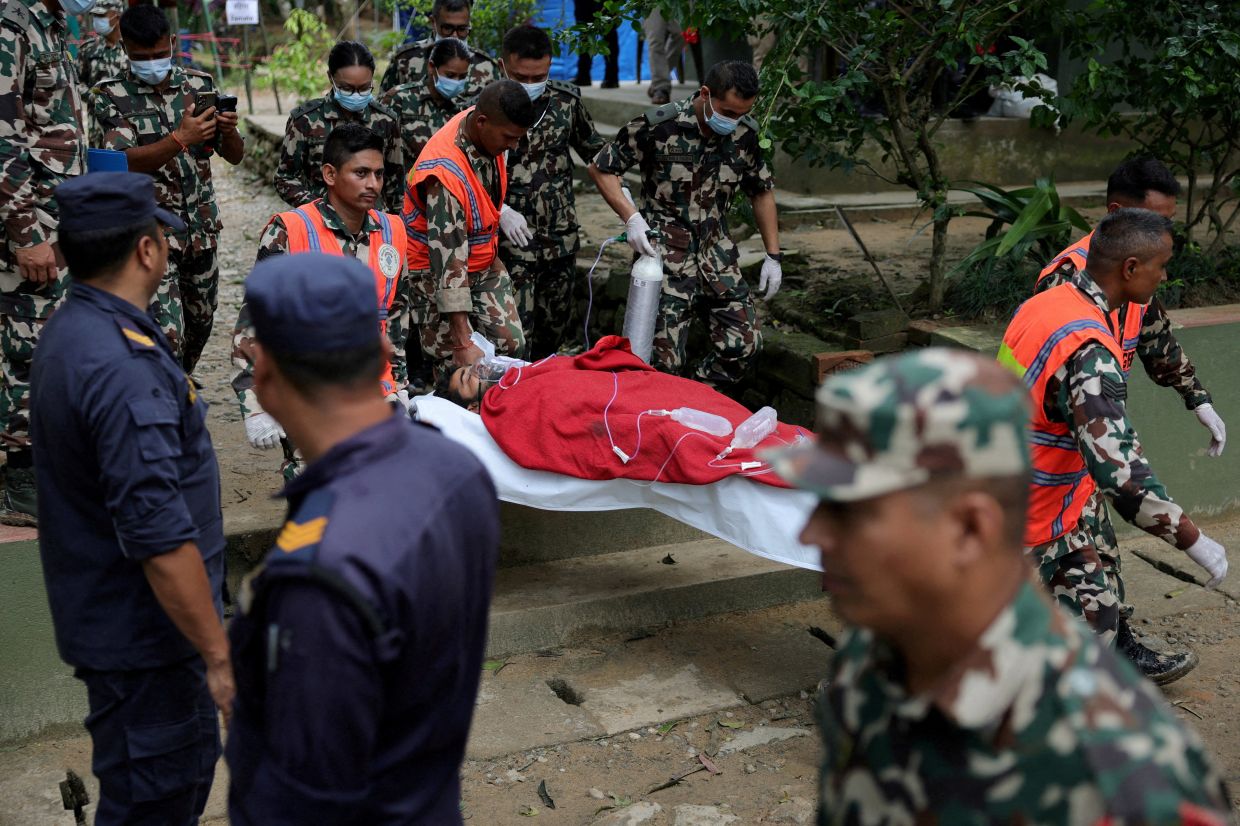 Sanjay Sah, a survivor rescued from a tunnel of the Upper Trishuli 3A hydropower project nine days after the deadly flash floods and a mudslide, is being carried to be air lifted to Kathmandu from an army base in Nuwakot, Nepal, Sept 4, 2026. - Photo: Reuters