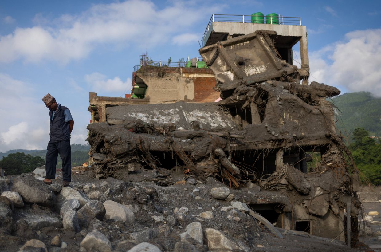 A man stands next to a damaged house, following deadly flash floods and a mudslide, in Trishuli, Nuwakot district, Nepal, Sept 8, 2026. - Photo: Reuters