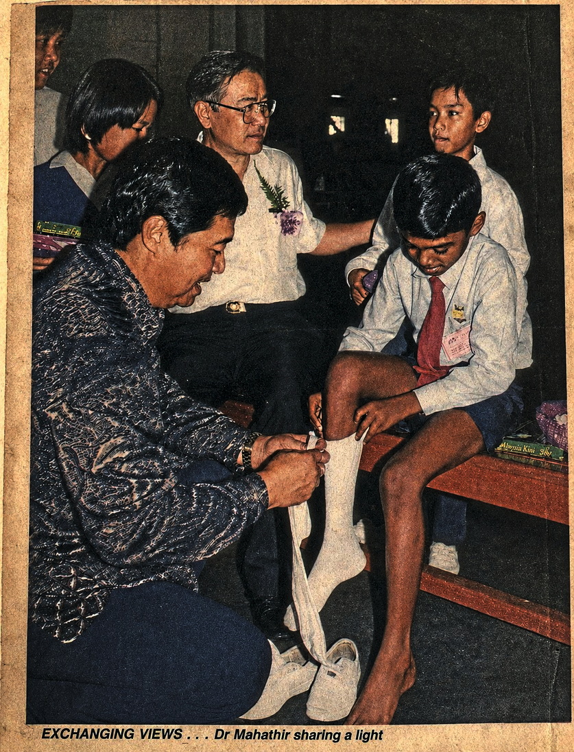A newspaper clipping dated Dec 31, 1994, of an 11-year-old Yogentharan with the late Dr Ling, who helped him put on his socks.