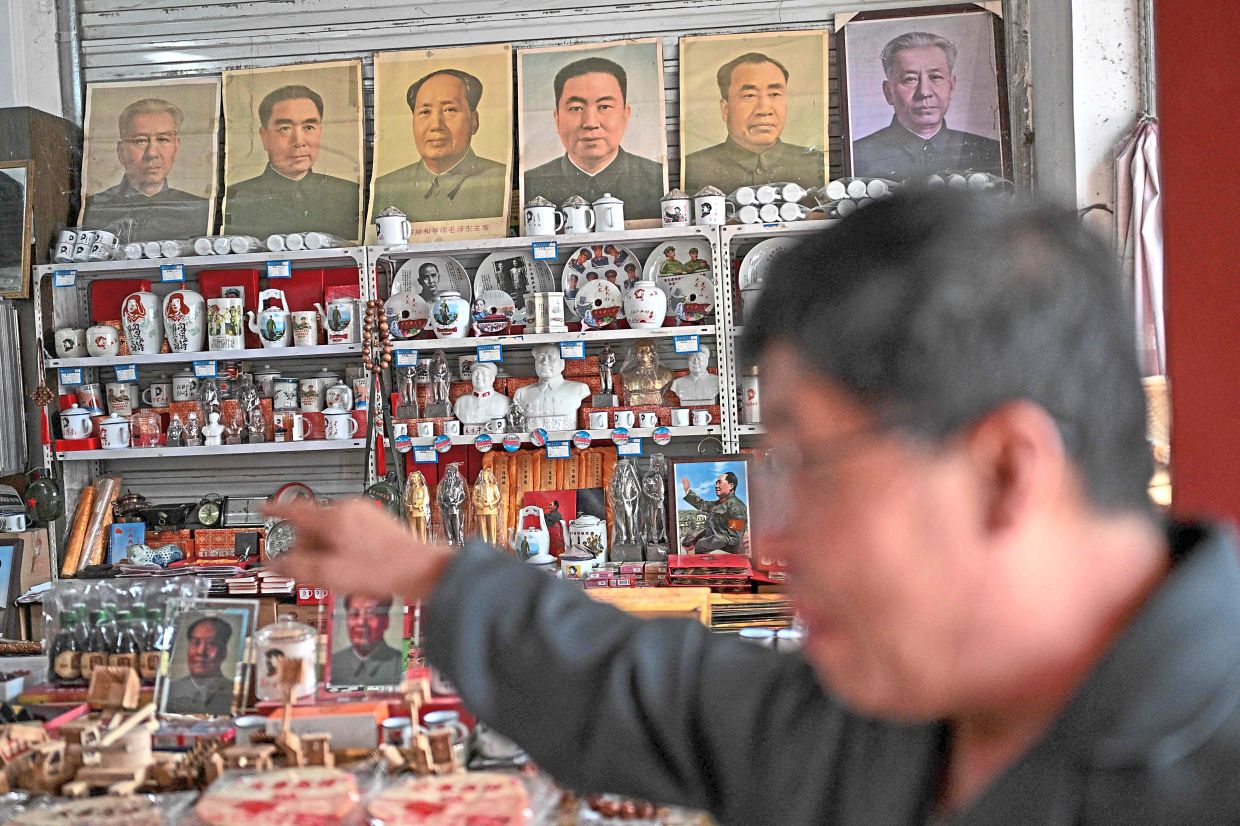 A vendor displays souvenirs featuring late Communist leader Mao Zedong and other Chinese leaders at a shop in Dazhai, northern China’s Shanxi province. Photo: AFP
