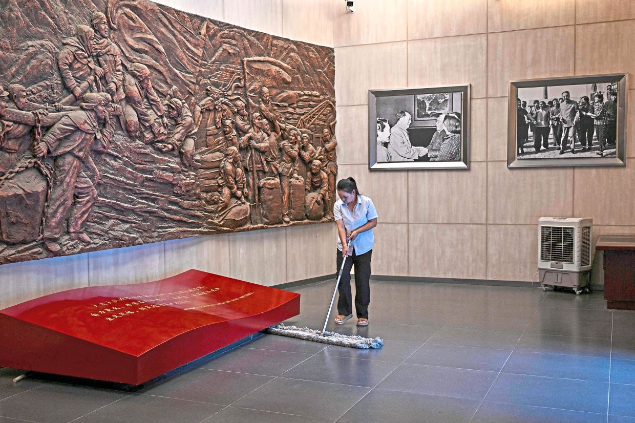 A staff member cleans the floor of an exhibition hall at the Dazhai Museum in Dazhai, northern China’s Shanxi province. Photo: AFP