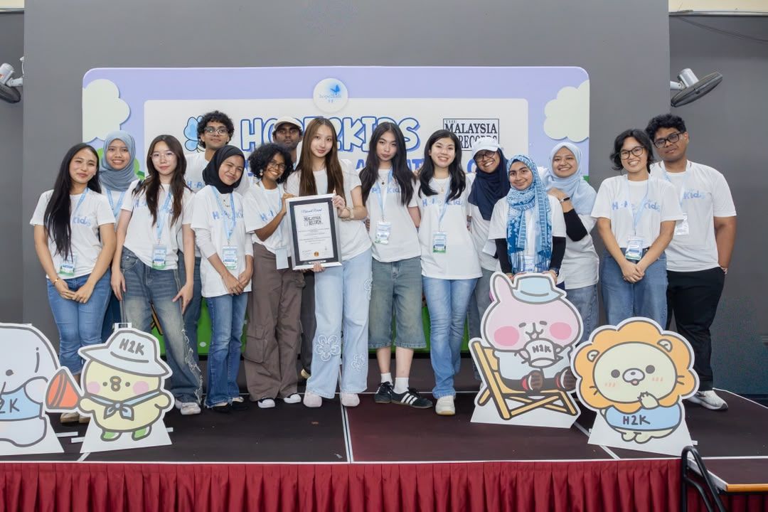 Ng (front row, fifth from left) and her team hopes that the milestone will help them reach out to more children through their initiatives. Photo: Hope2Kids