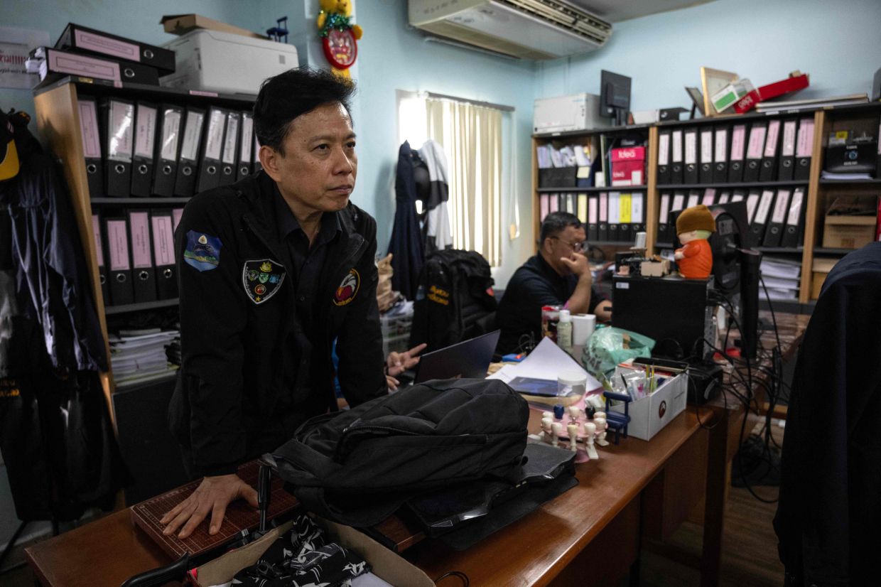 Head of the raid unit at the Department of National Parks, Wildlife and Plant Conservation, Nawee Changpirom, monitoring at the DNP headquarters in Bangkok. - AFP