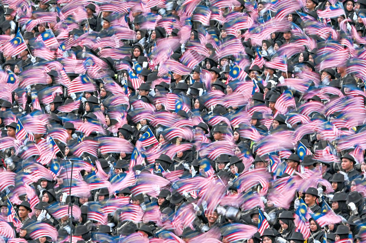 1 Malaysians in ethnic attire bringing colour to the celebration.2 An RMAF fighter jet deploying flares during a dramatic flypast.3 Prisons Department’s K9 unit personnel with their partners.4 Members of police mounted unit on parade.5 Animation characters Upin and Ipin waving to the crowd from a float.6 A drum troupe captivating spectators with an energetic performance.7 Thousands waving the Jalur Gemilang with pride.