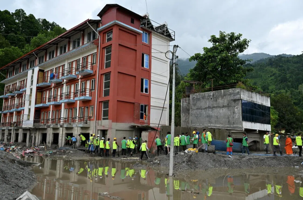 Dozens answered the call by disaster response non-profit Mission Rebuild Nepal for volunteers to remove silt from salvageable buildings in Devighat. - ST/DESMOND FOO