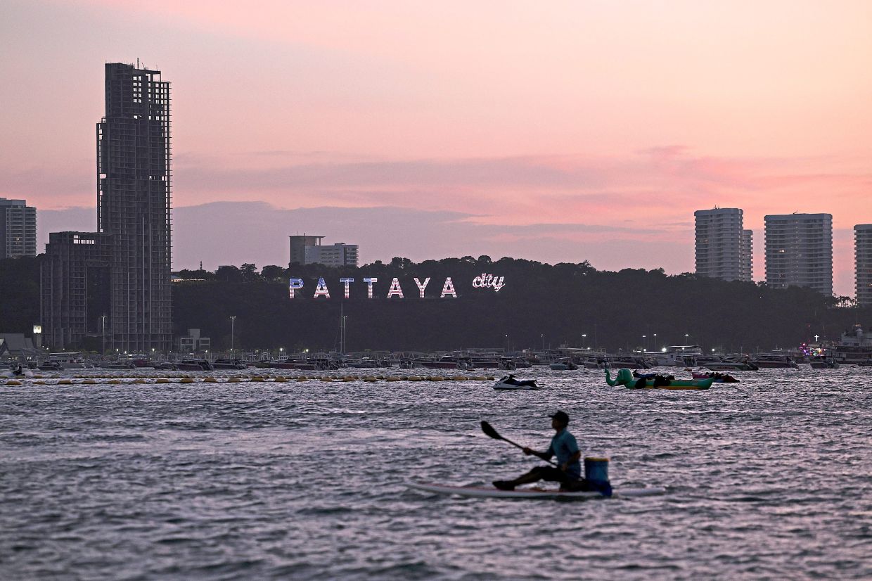 A sign lit with the colours of the US flag welcoming American military personnel from the USS Abraham Lincoln to Pattaya.