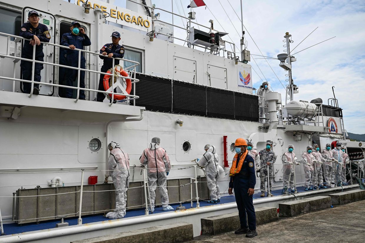 Philippine Coast Guard personnel in protective suits prepare to unload body bags of victims from the ferry fire blaze to a tent for identification at the port of Borac in Coron, Palawan province on Sept 13, 2026. The death toll from a Philippine ferry fire jumped to 76 on Sept 12 after the coast guard confirmed the discovery of 41 more bodies aboard the burnt-out vessel. - Photo: AFP