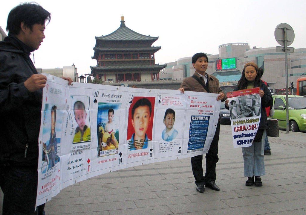 For many Chinese parents, the search involves agonising public appeals, from holding banners to driving custom poster-covered vehicles. - Photo: Getty Images via AFP