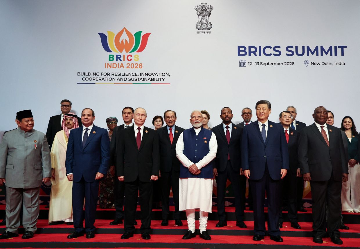 Heads of delegations, including Indonesian President Prabowo Subianto, Egyptian President Abdel Fattah al-Sisi, Russian President Vladimir Putin, Indian Prime Minister Narendra Modi, Chinese President Xi Jinping, South African President Cyril Ramaphosa, Saudi Foreign Minister Prince Faisal bin Farhan Al-Saud, Uzbekistan Deputy Prime Minister Jamshid Kuchkarov, Malaysian Prime Minister Datuk Seri Anwar Ibrahim, Ethiopian Prime Minister Abiy Ahmed, Vietnam's Prime Minister Le Minh Hung, pose for a family photo on day two of the BRICS Summit in New Delhi, India, September 13, 2026. -- Photo: Sputnik/Alexander Kazakov/ via REUTERS
