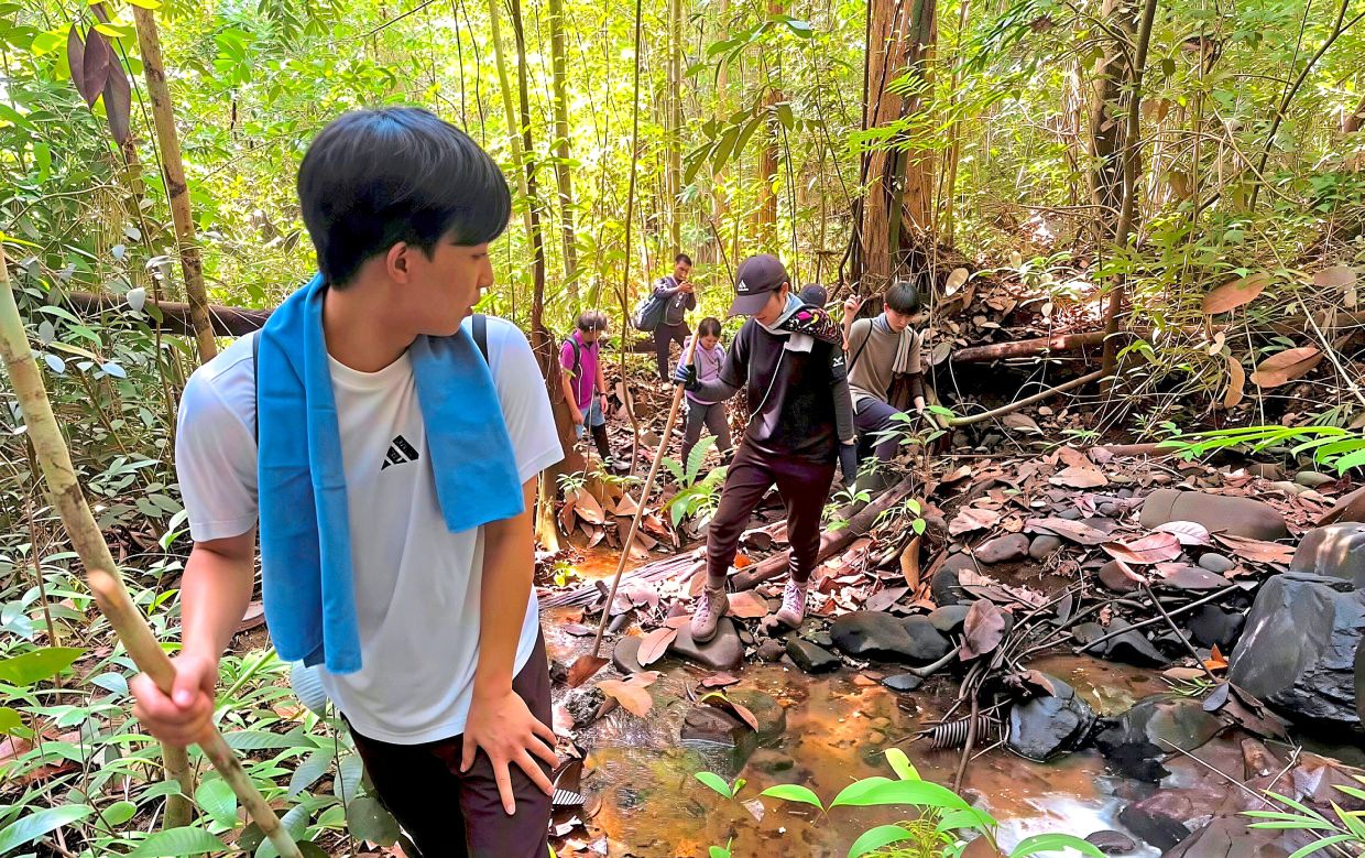 The Japanese group making its way through the forest along part of the Sandakan-Ranau Death March route in Telupid.