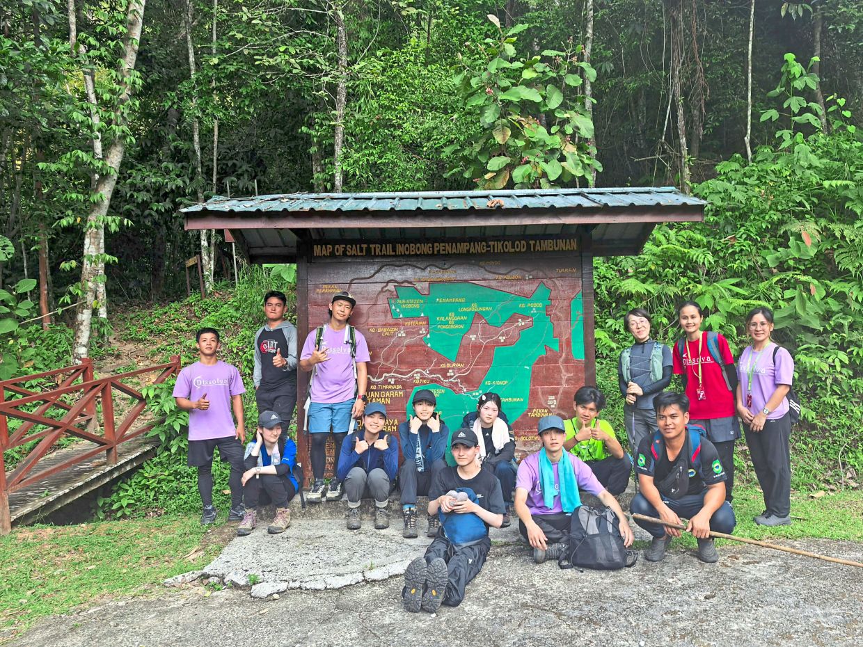 Majima (standing, third from right) with her university students and local guides after completing part of the Sandakan-Ranau Death March trail in Telupid.