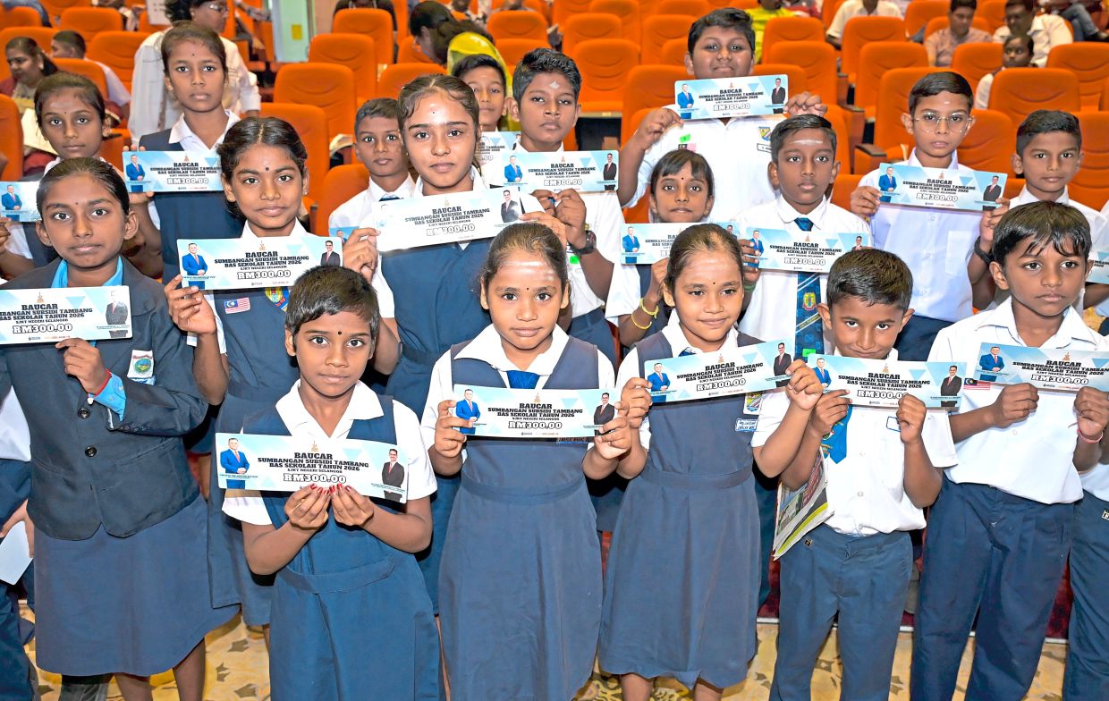 Pupils with their RM300 school bus fare subsidy vouchers.