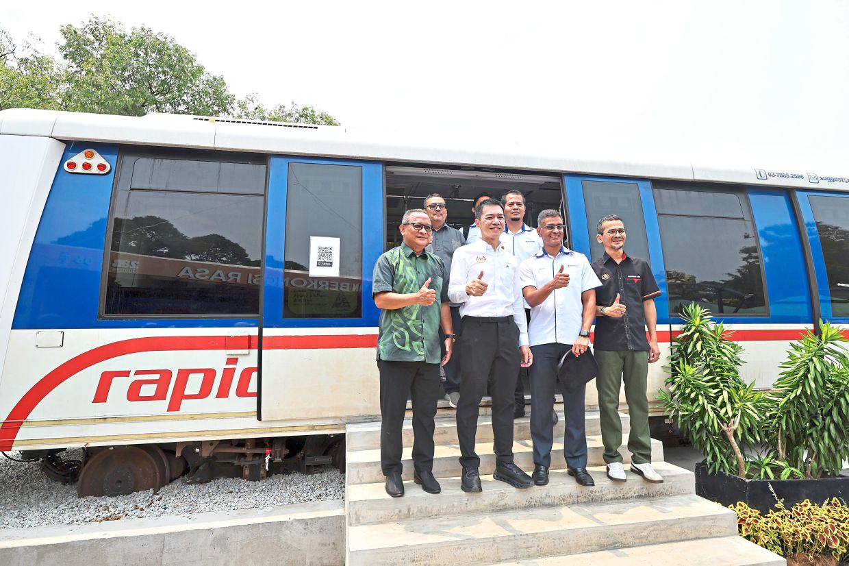 (From left) Labuan Corporation chief executive officer Rithuan Ismail, Lo, Prasarana Malaysia acting group stakeholder experience management and marketing department head Ashok Panchalingam and Muhammad Azmi posing in front of the LRT coach at the event.