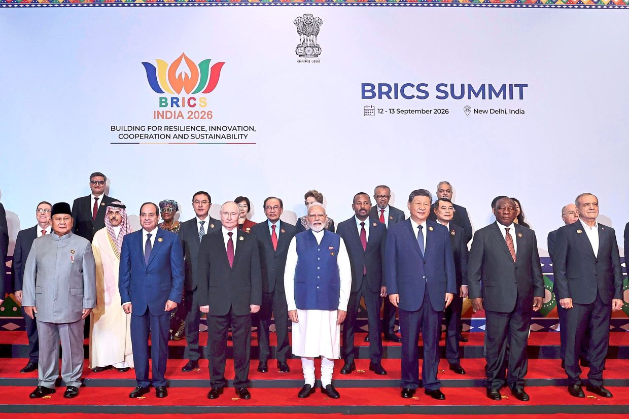 A new order: Anwar (second row, fourth from left) posing for a group photo with BRICS leaders, partners and outreach invitees during the 18th BRICS Leaders’ Summit in New Delhi. — Bernama