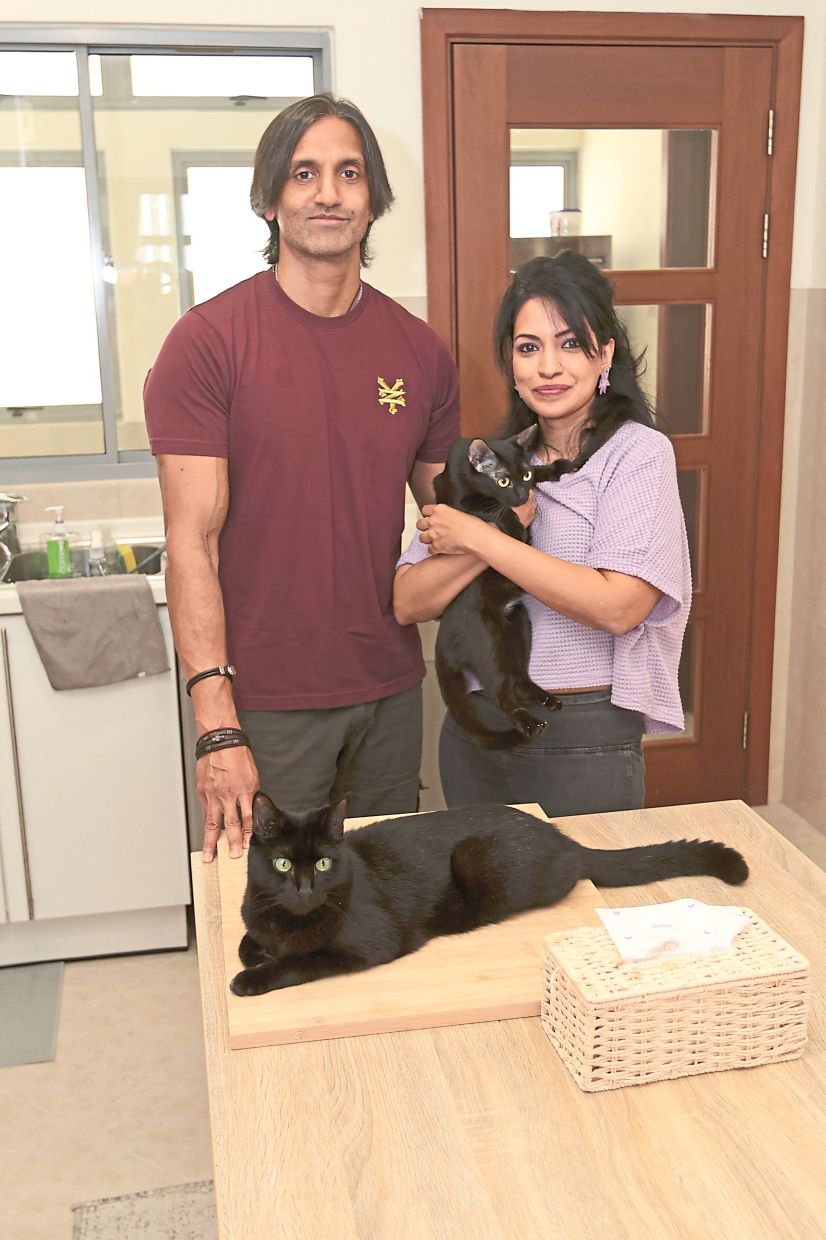 Naidu and Letticia chose to adopt black cats to complete their lives. — LOW BOON TAT/The Star