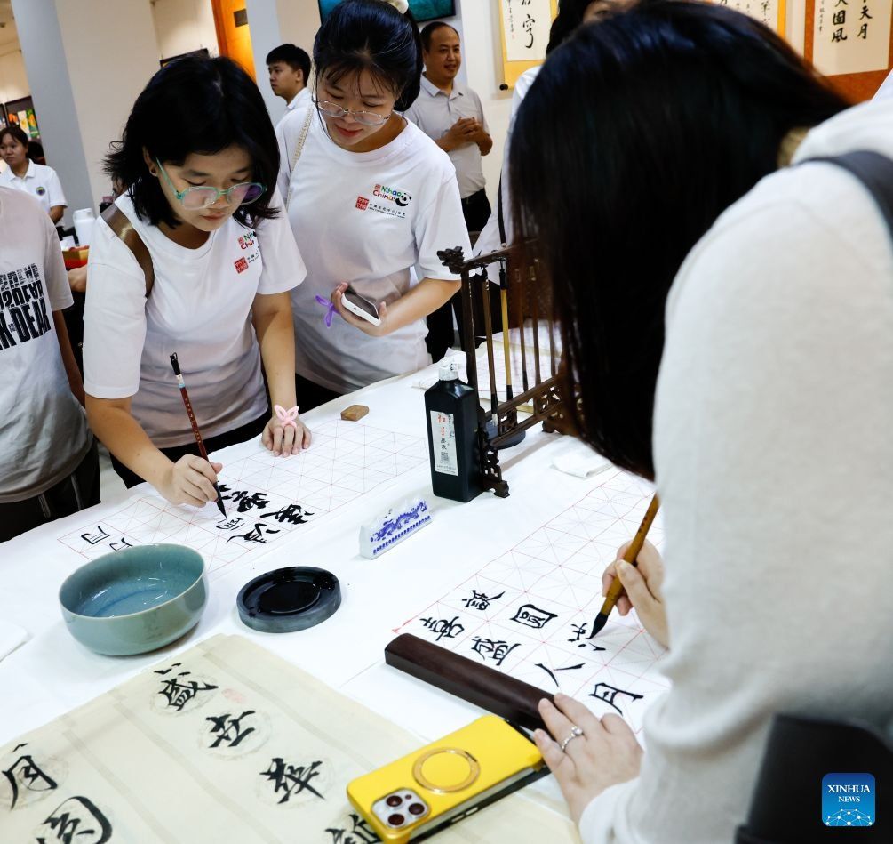 People write Chinese calligraphy during an event to celebrate the upcoming Mid-Autumn Festival at the China Cultural Centre in Yangon, Myanmar, Sept 12, 2026. - Photo: Xinhua