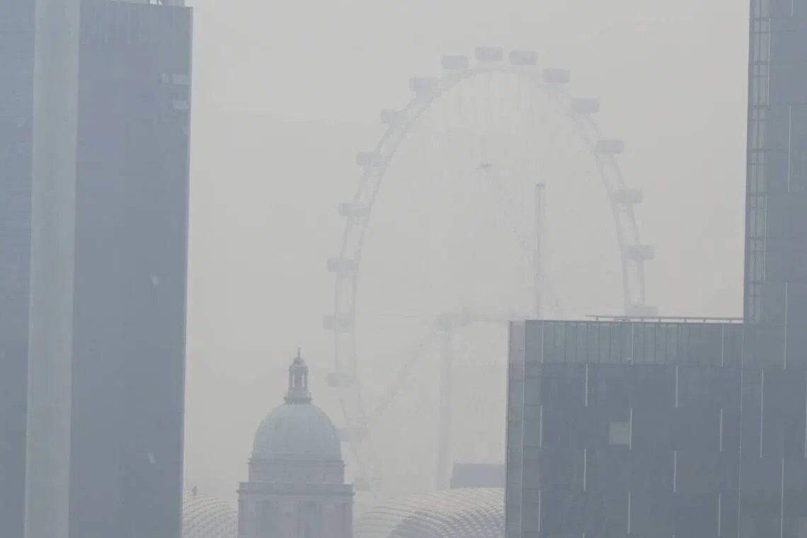 The Singapore Flyer shrouded in haze as seen from Robertson Quay at about 10am on Sept 14. -- ST PHOTO: CHONG JUN LIANG/ ANN