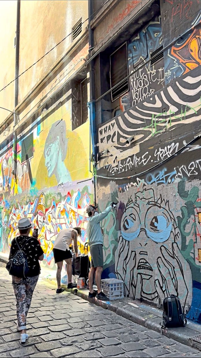 At Melbourne's Hosier Lane, you can sometimes watch artists working on their murals and other artworks.